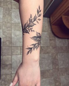 a woman's arm with a flower tattoo on it