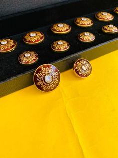 "Each button is handcrafted and enamelled by the finest craftsmen in Jaipur. Handcrafted Indian Sherwani Button,Jodhpuri Maharaja Look Kundan Meena Jewellery,Gold plated Button Size:  Big : 22mm Diameter           Small : 18mm Material : Brass With !4k Gold plating                  Silver 925 With Certification The price reflected is for 7 big and 6 small buttons. All our pieces are plated with gold and secured with a high quality coating to increase the life of the plating we provide a proper button box for the safety and proper care of the buttons  Shipping Information  ❥Express Shipping UPS, FedEx ❀ All country is free shipping. ❀ Orders are shipped in the next day or within 3-5 business days from India ❀ Time of delivery for United States, Canada etc. will take 7-8 business days after Elegant Meenakari Sets For Ceremonial Occasions, Traditional Formal Sets With Buttons, Traditional Bandhgala With Buttons For Formal Occasions, Traditional Formal Bandhgala With Buttons, Traditional Wedding Sets With Buttons, Ceremonial Gold Sets With Motifs, Traditional Kundan Formal Sets, Traditional Festive Sets With Buttons, Traditional Kundan Sets For Formal Occasions