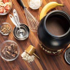 an assortment of ingredients on a wooden table including bananas, chocolate and other foodstuffs