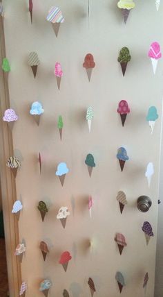 an ice cream themed wall hanging on the side of a door with paper cones attached to it