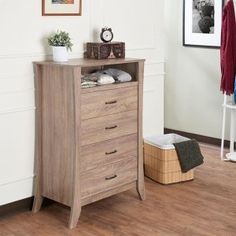 a chest of drawers in the corner of a room