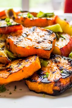 grilled vegetables are arranged on a white plate