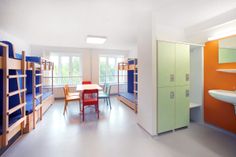 a room filled with bunk beds next to a sink