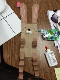 a paper bunny sitting on top of a wooden table