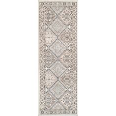 a beige and blue rug with an intricate design on the bottom, in front of a white background