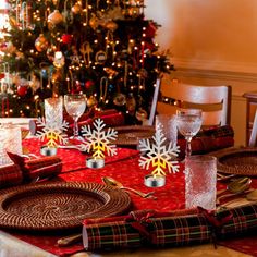 a table set for christmas with plates and silverware