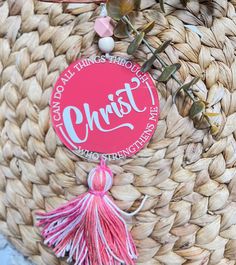 there is a pink sign that says christ hanging from the handle of a woven basket