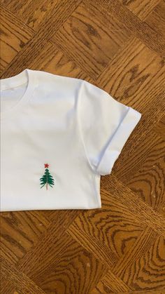 Hand Embroidered T-Shirt Christmas White Embroidered Tops, White Embroidered Crew Neck Shirt, White Tops With Custom Embroidery For Christmas, White Tops With Embroidered Logo For Christmas, White Top With Embroidered Logo For Christmas, White Christmas Tops With Embroidered Graphics, White Crew Neck Tops With Machine Embroidery, White T-shirt With Machine Embroidery, Short Sleeve, White Short Sleeve Tops With Machine Embroidery