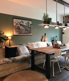 a living room filled with furniture next to a kitchen and dining room table in front of a window