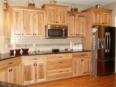 a kitchen with wooden cabinets and stainless steel appliances