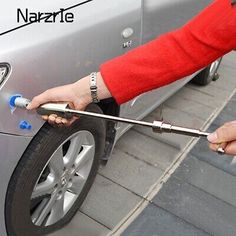 a person is changing the brake lever on a car's front tire with a wrench