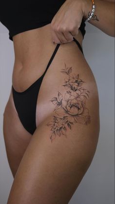 a woman's stomach with flowers on it and the bottom part of her body