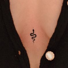 a woman's chest with a small tattoo on the left side of her stomach