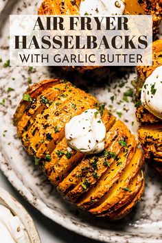 grilled potatoes with garlic butter and parsley on a white plate, topped with whipped cream