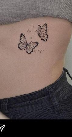 two butterflies on the side of a woman's stomach, one is black and white