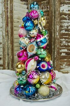 a small christmas tree made out of ornaments