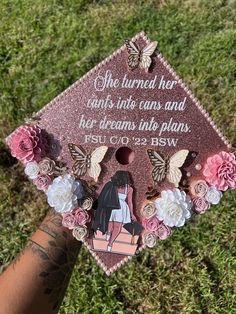 someone is holding up a pink graduation cap with flowers on it and the words she turned her shots into cans and her dreams ink plans