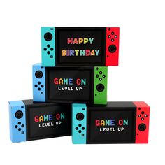 four different colored boxes with the words happy birthday and game on written in black letters