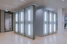 two glass partitions in the middle of an empty room