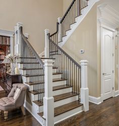 a living room filled with furniture and a stair case