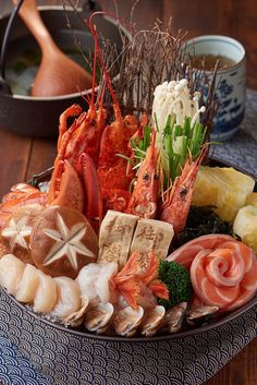 a platter filled with assorted seafood and vegetables