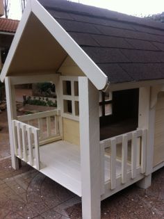 a white dog house sitting on top of a patio