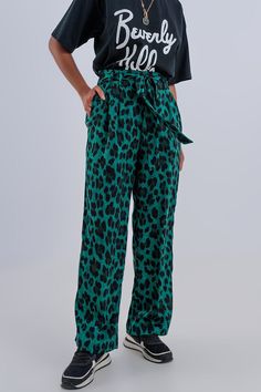 Beautiful printed wide leg trousers in a silky-soft, green animal print, with an elastic waist on the back of the waistband and a matching belt. There are utility pockets on the side of these flowy, soft, and comfy trousers. The fabric is made from 100% Polyester. Just add a t-shirt or a shirt in one of the accent colors, to complete the fabulous look. We show the trousers with our Beverly Hills T Shirt in Black, in our photos. The model is 5’6” with measurements of 32-24-34 and is wearing a siz Tan Scarf, Green Leopard Print, Leopard Print Pants, Printed Wide Leg Pants, Pantalon Large, Printed Pants, Hat Hairstyles, Wide Leg Trousers, Cute Stuff