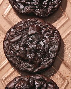 three chocolate cookies sitting on top of each other