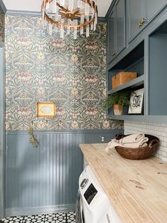 a washer and dryer in a room with wallpaper on the walls behind it