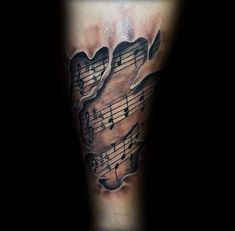 a man's leg with music notes on it