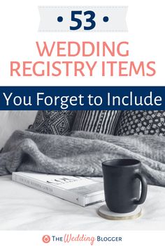 a coffee cup sitting on top of a bed next to a book with the title 53 wedding