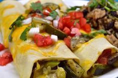 an enchilada on a plate with salsa and rice