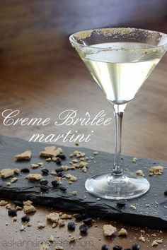 a martini glass filled with white wine and garnished with black pepper flakes