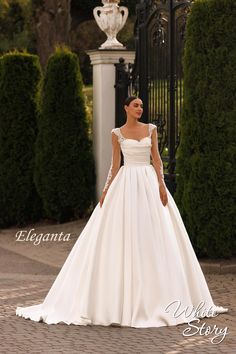 a woman in a white wedding dress standing outside