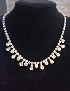 Amazing rare item ! Beautiful Blush pink and golden undertones in the hard to find champagne Aurora Borealis riviera necklace set yellow gold plated metal. Perfect accessory for blush pink gown or formal wear .. in very good vintage condition, all stones are bright and intact. Adjustable length with hook closure , measuring just under 16 inches. Dazzling Jeweled Necklaces For Celebration, Teardrop Prong Setting Jewelry For Party, Drop Jewelry With Prong Setting For Party, Gold Dangle Necklaces With Sparkling Stones, Classic Gold Necklace With Sparkling Stones, Costume Jewelry Rhinestone Dangle Necklace, Formal Dangle Rhinestone Necklaces, Formal Rhinestone Dangle Necklaces, Gold Teardrop Jewelry With Rhinestones