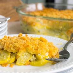 a white plate topped with food next to a casserole dish