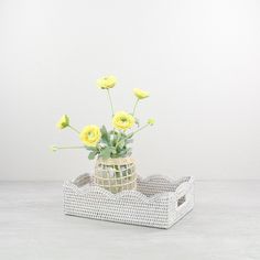 a basket with flowers in it sitting on the floor