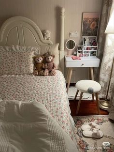 two teddy bears are sitting on the bed in this bedroom with floral bedspread