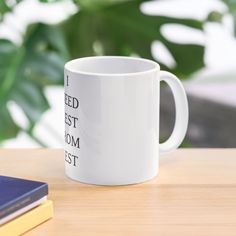 a white coffee mug sitting on top of a wooden table