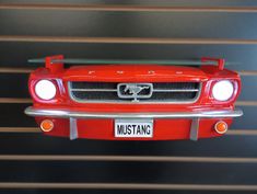 the front end of a red mustang car