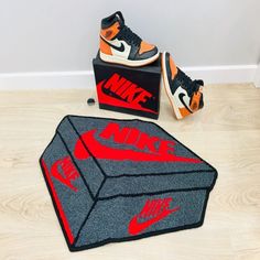 Step up your interior game with these unique and modern Nike Air Jordan 1 Sneaker Box shaped rugs! Made of wool and acrylic, these hand-tufted rugs are eco-friendly, allergy-friendly, and easy to clean. Perfect for any room, these rugs come in a size of 80 cm x 60 cm. Get yours today! #Nike #AirJordan #SneakerBox #sneakerhead #hypebeast Shape Rugs, Shaped Rugs, Rugs Bedroom, Sneakers Box, Tufted Rugs, Bedroom Accent, Living Room Rugs, Nike Air Jordan 1, Allergy Friendly