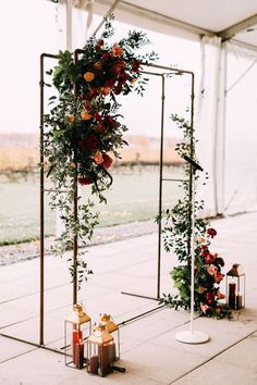 an outdoor ceremony setup with flowers and candles