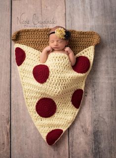 a baby is laying in a crocheted blanket