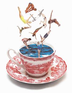 a teacup with people floating in it on top of the cup and saucer