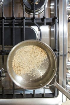 a frying pan filled with food sitting on top of an open stove burner