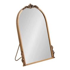 a large mirror sitting on top of a wooden stand