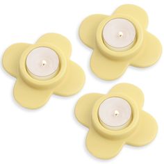 two yellow flower tealight candles sitting on top of each other