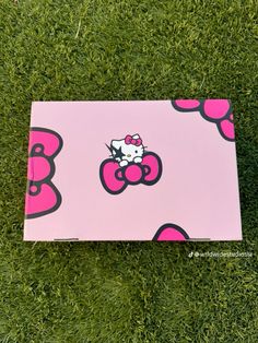 a hello kitty box laying on the grass