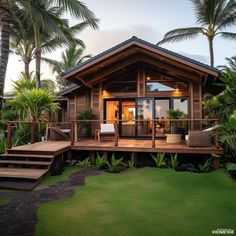 a small wooden house surrounded by palm trees and lush green lawn area with steps leading up to the front door