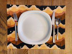 a white plate with silverware on top of it next to a fork and knife